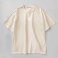 A beige oversized crew neck t-shirt with short sleeves and a front graphic print of the TS logo. 